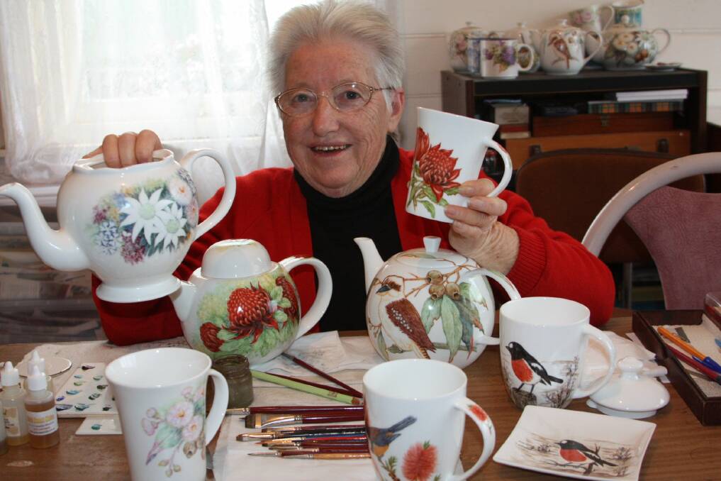 CUSTOM DESIGNS: Florence Humphreys with her painted teapots and cups. Picture: Stephen Wark