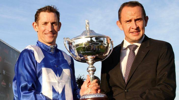 Cup success: Jockey Hugh Bowman and trainer Chris Waller celebrate after winning the Queensland Oaks with Winx.  Photo: Tertius Pickard