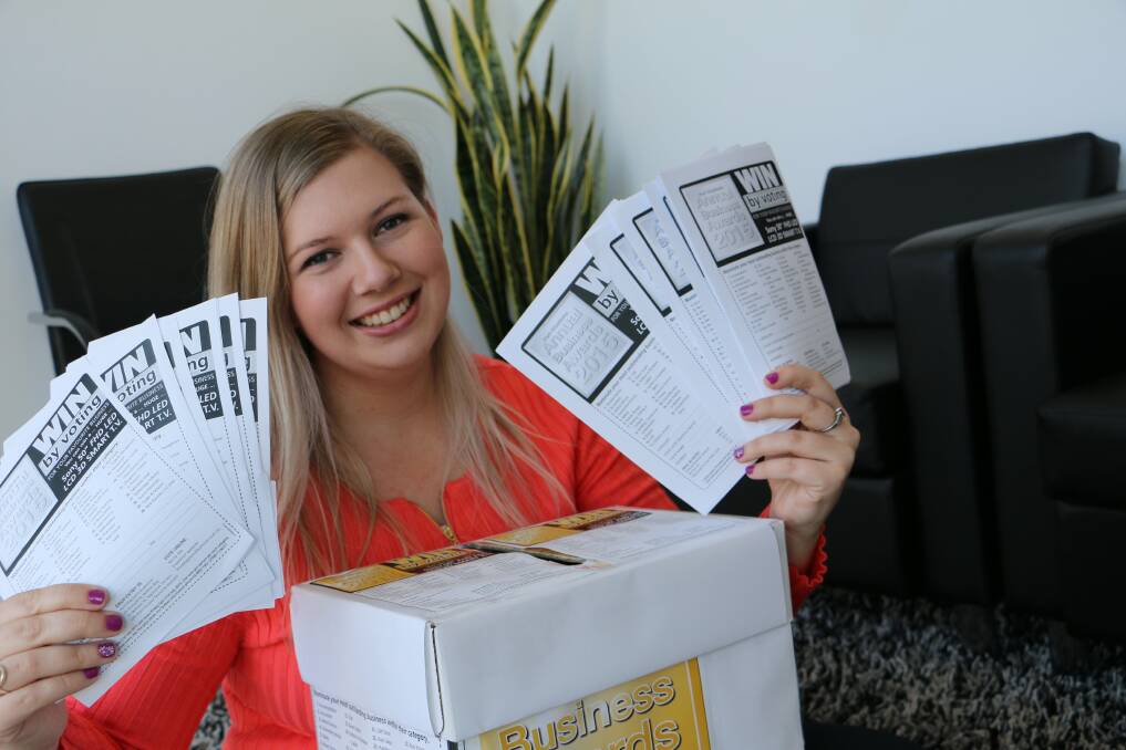 TV ON OFFER: Examiner staff member Abbie Stephen with Annual Business Awards voting forms.