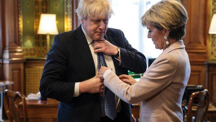 British Foreign Secretary Boris Johnson has his tie straightened by his Australian counterpart Foreign Minister Julie Bishop. Photo: Jack Taylor/Pool