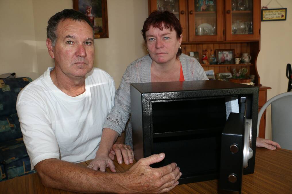 GUTTED: Stephen and Jane Fisher at their home in Raymond Terrace with their new safe. Picture: Stephen Wark