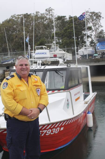 FIREMEN AFLOAT: Captain Dave Brown with the rural fire service boat at Soldiers Point Marina. Picture: Charles Elias