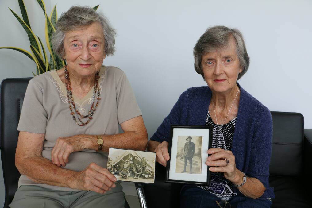 MEMORIES: Raymond Terrace sisters Joan Johnson and Margaret Rissler with pictures of their father, Joseph Arnold Palmer. Picture: Ellie-Marie Watts