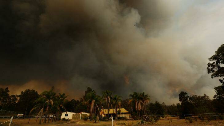 The bushfire flares over properties in Kurri Kurri Photo: Jonathan Carroll