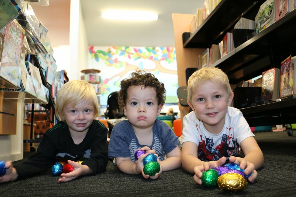 SUCCESSFUL HUNT: Lucas Cheetham, 3, Jassim Al Muraibt, 2, and Theodore Dent, 4, at Raymond Terrace Library. Picture: Ellie-Marie Watts