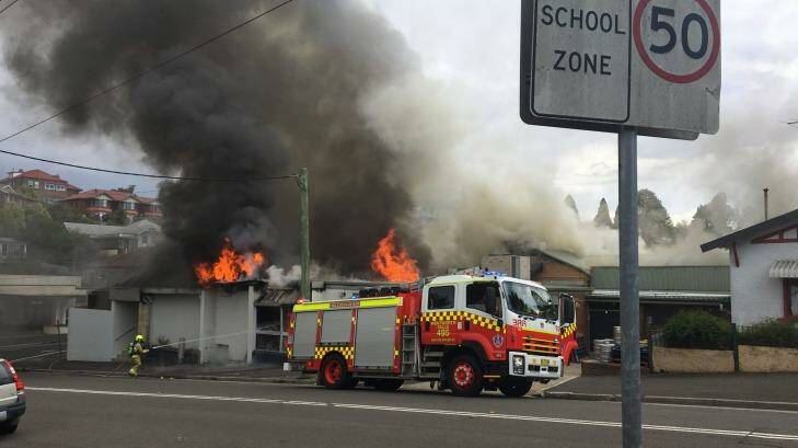 Smole and flames rise from the building, which was safely evacuated. Photo: Sean Glassford