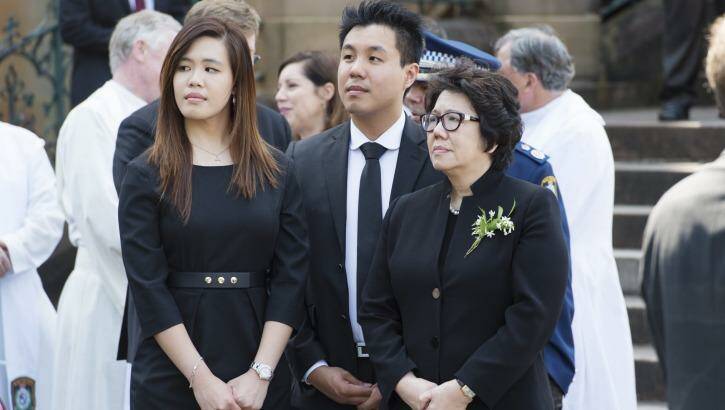 Mrs Cheng with her children Alpha and Zilvia at her husband's funeral in October 2015. Photo: James Brickwood
