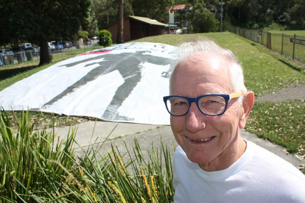 ON MESSAGE: Norman Ainsworth with his giant Peace is Possible banner. Pictures: Stephen Wark