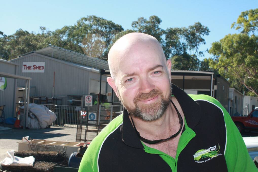 SHINE ON: Gerard McClafferty in front of the energy saving rooftop solar panels. Picture: Stephens Wark