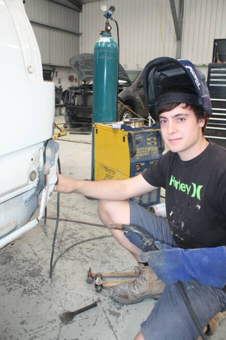 PLEASED: Apprentice Damien Crew, 18, at Anthony Lloyd Smash Repairs shop in Salamander Bay. Picture: Stephen Wark