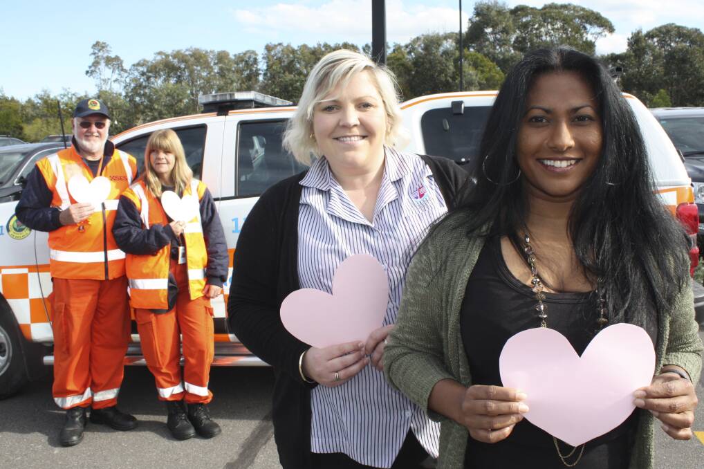 THANKS: Tomaree SES members Bob Parrish and Penny Casey promote the fundraiser with marketing co-ordinator Abby Richards and centre manager Dushani Gamage. Picture: Charles Elias