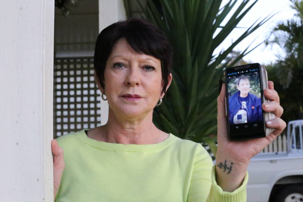 HAVE YOU SEEN THIS MAN?: Kathie Case, the sister of missing Williamtown man Michael Fowler, holds up her most recent photo of him, taken in June. Picture: Ellie-Marie Watts
