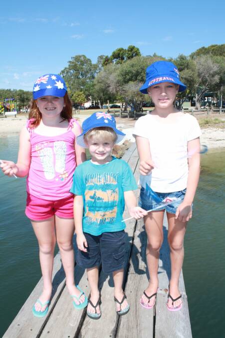 BRING IT ON: Getting in the mood for the Tilligerry Australia Day celebrations are Charlee Sheather, 7, Mitchell Humbles, 5, and Emma Zdebski, 8, all of Tanilba Bay. Picture: Stephen Wark