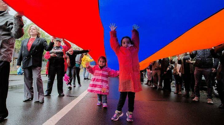 Sisters Leila, 3, and Natalie, 6, march through Chatswood under an Armenian flag to commemorate the 1915 genocide. Photo: Michele Mossop