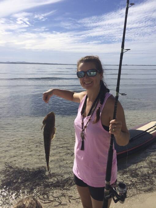 STAND-UP SUCCESS: Natasha Styles catches flathead on her paddle board.