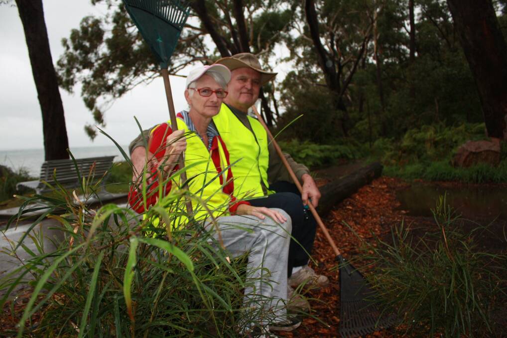 SPARE TIME: Volunteers Dennis and Jan Wells at the cleared Bagnalls Beach Reserve. Picture: Stephen Wark