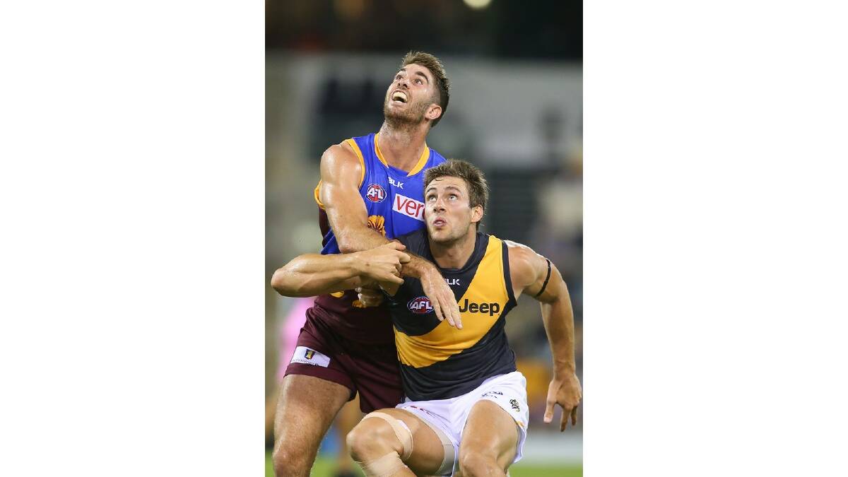 Jordan Lisle of the Lions and Shaun Hampson of the Tigers compete for the ball during the round five AFL match between the Brisbane Lions and the Richmond Tigers at The Gabba on April 17, 2014 in Brisbane, Australia. Photo: Chris Hyde/Getty Images.
