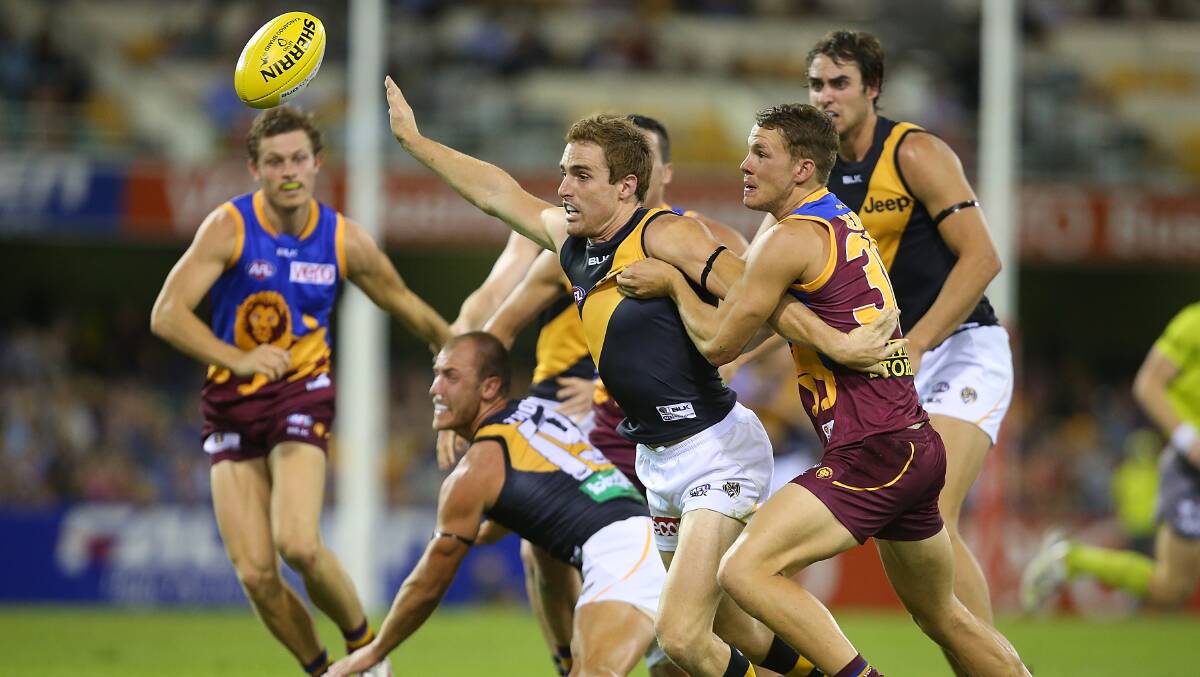 Dan Jackson of the Tigers and Jack Redden of the Lions compete for the ball during the round five AFL match between the Brisbane Lions and the Richmond Tigers at The Gabba on April 17, 2014 in Brisbane, Australia. Photo: Chris Hyde/Getty Images.