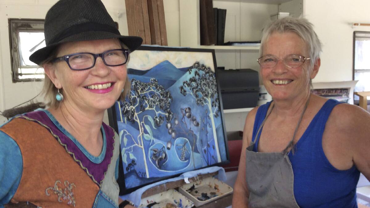 STEPPING UP: Artists Louise Young and Christine du Fresne put finishing touches on their work for the exhibiton.