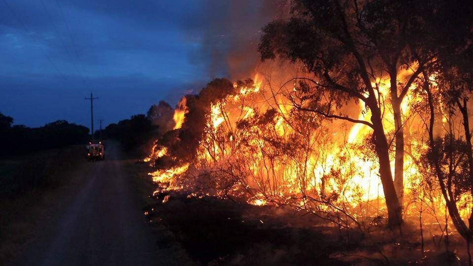 UNDER CONTROL: Backburning by the RFS along Rookes Road Tuesday night. Picture from Raymond Terrace Rural Fire Service/Facebook.