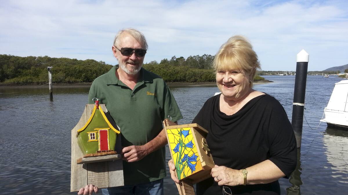BAT-LERS: Myall River Art Walk members David Matheson and Cheryl Cook with a ceramic and painted wooden bat flat.