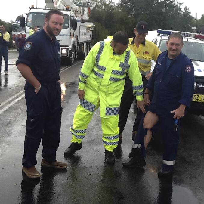 RIPPED UP: Senior Constable Brad Smith and a police rescue officer, examine paramedic Bill Rathbone’s pant leg.