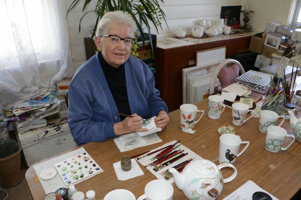 DETAILED WORK: Florence Humphreys at her home in Raymond Terrace handpainting cups, mugs and teapots. Picture: Stephen Wark