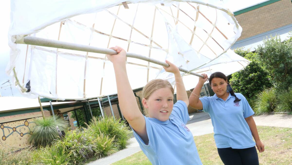 LANTERNS: Tea Gardens Public School students Aaliyah Masina, 11, and Charlotte Bultitude, 12, with a lantern they made for the Myall River Festival.