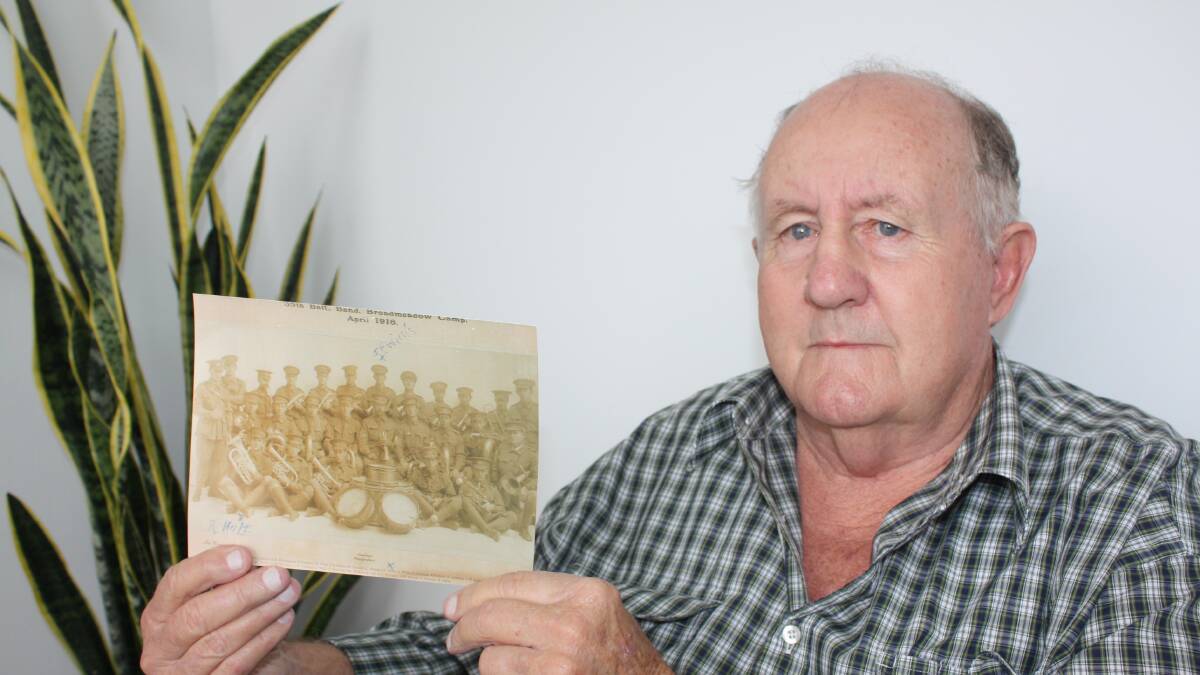 Raymond Terrace resident John Wilson holds a photograph of the Newcastle zone battalion featuring his grandfather, Joseph Francis Willis.