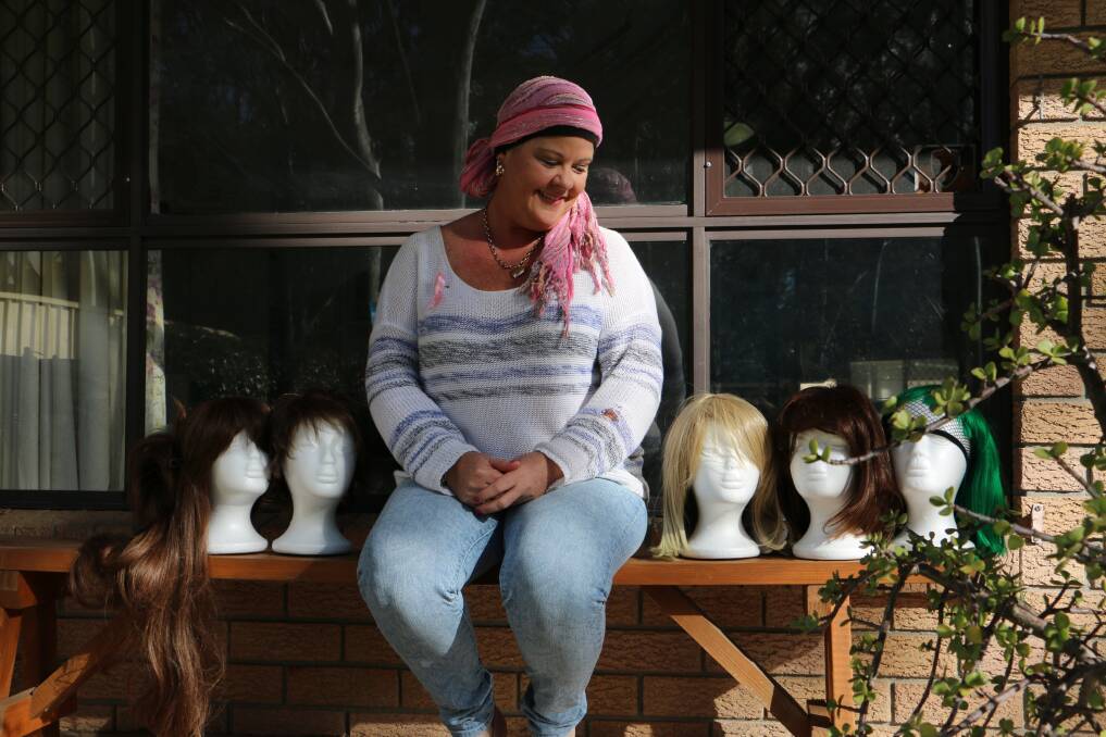 SURVIVOR: Keryn Barnett, who is recovering from breast cancer, at her home in Raymond Terrace with the wigs she collected throughout her treatment. Picture: Ellie-Marie Watts