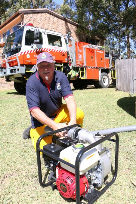 QUICK FILL: North Arm Cove RFS firefighter Steve Gee with the brigade's new water pump. Picture: Stephen Wark.