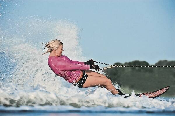 BENCHMARK: World No.1 waterskier Karina Nowlan at home at Salt Ash yesterday and at home on the water.- Pictures by Jonathan Carroll and Bill Doster