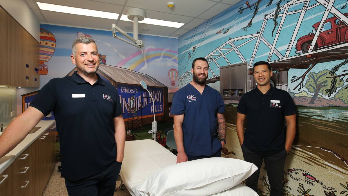 Heal Urgent Care CEO Dr Tim Stewart, director of nursing Jason Carney and people experience manager Nico Vierne in the procedure room, which features Maitland-centric artwork by Mitch Revs. Picture by Simone De Peak