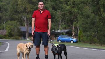 Thornton resident Paul Johns with retired guide dog Keith (left) and his current guide dog Tate (right). Picture by Simone De Peak