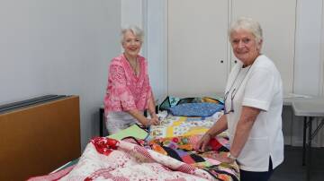 Colleen Maloy and Jan Hall prepare for the quilt and craft show. Picture by Laura Rumbel
