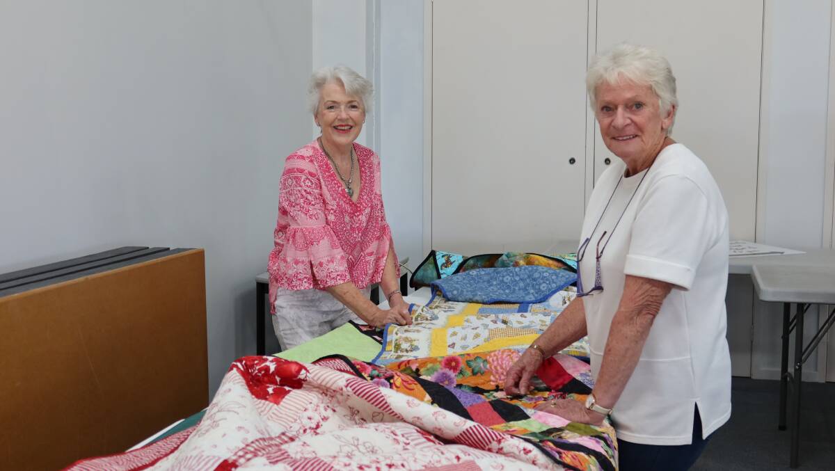 Colleen Maloy and Jan Hall prepare for the group's quilt and craft show next week. Picture by Laura Rumbel