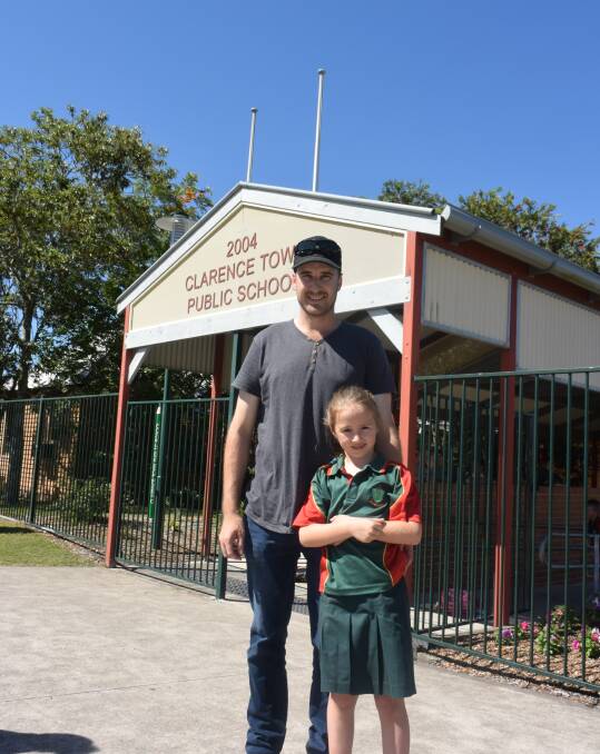 UNHAPPY: Clarence Town Public School P&C President Matt Brown, pictured with his daughter Marlee outside the school, plans to continue to lobby for a bus service.