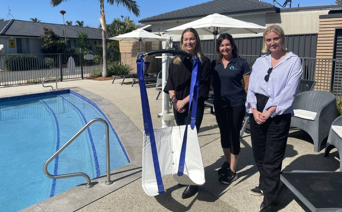 Ariel App designers Jordy Freeman (left) and Kate Maslen (right) are shown by Seaside Holiday Resort manager De-Anne Anderson how to assemble a pool hoist.
