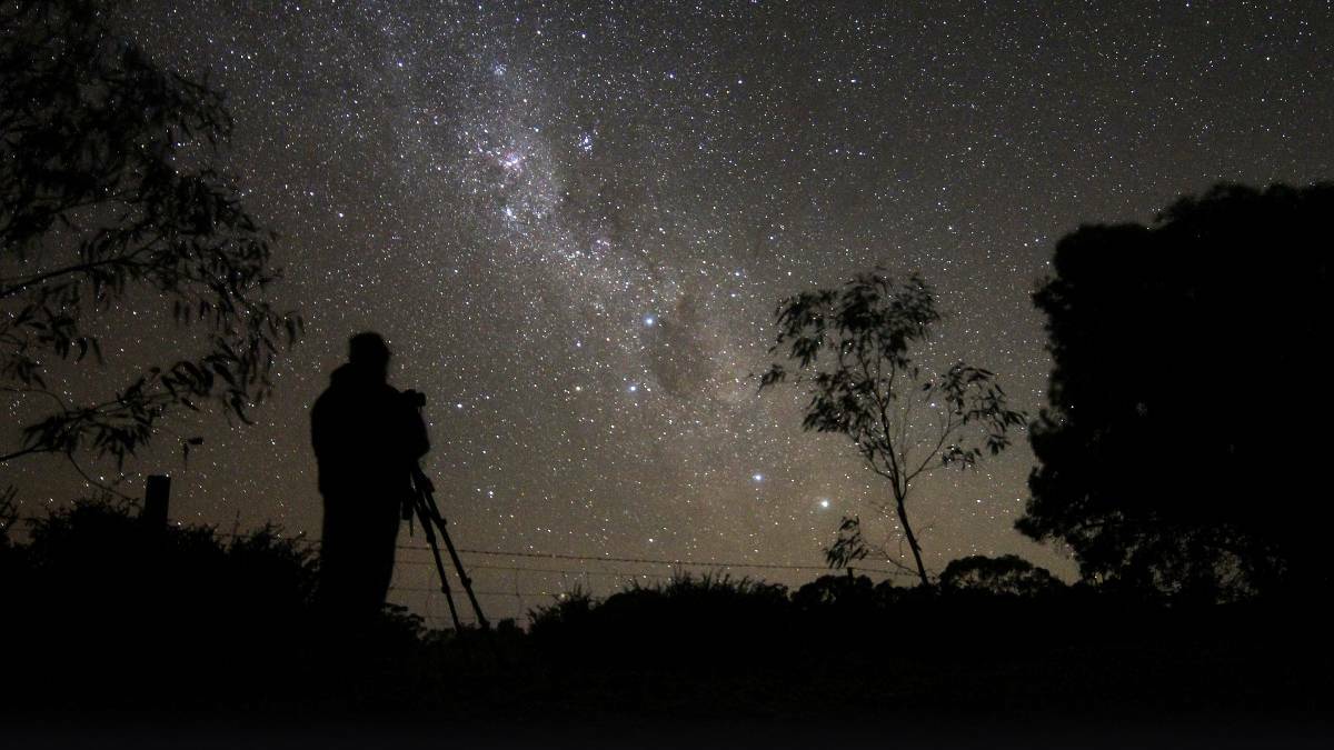 SPECTACULAR: University of SA astronomy lecturer Paul 'Starman' Curnow snapped gazing at the Milky Way at the River Murray Dark Sky Reserve. Photo: Graeme Stanley