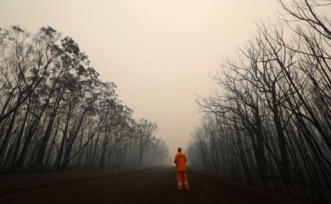 Journalist John Hanscombe takes in the devastation on the Nerriga Road near Nowra on the NSW South Coast on December 30, 2019. Picture: Sylvia Liber