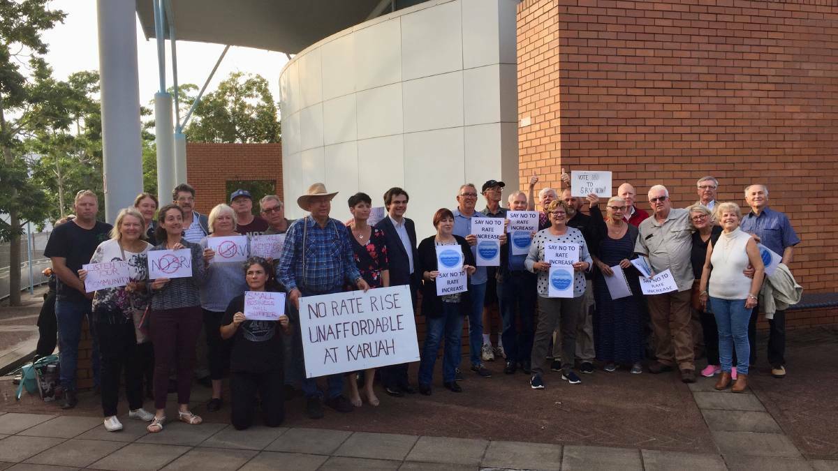 Residents against the rate rise with councillor Giacomo Arnott and Port MP Kate Washington outside the council chambers in October.