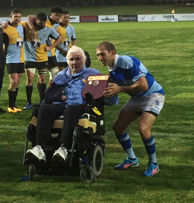 TOUGH WIN: Tony Wansey presents the shield named in his honour to Wanderers captain Luke Simmons. 