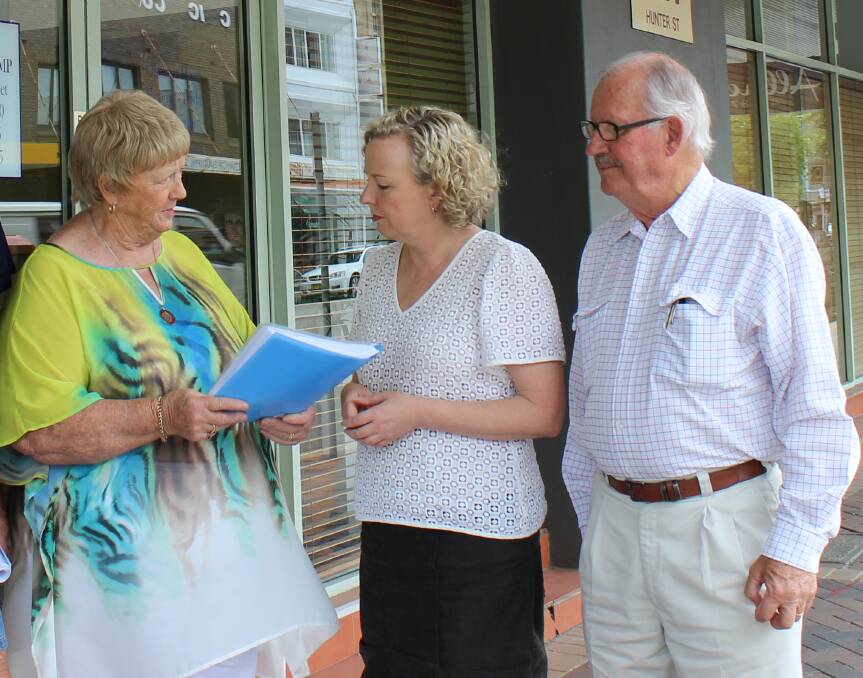FED UP: Wendy Ditton, left, and David Morrow, right, present Newcastle MP Sharon Claydon, centre, with a petition calling for action on mobile blackspots.
