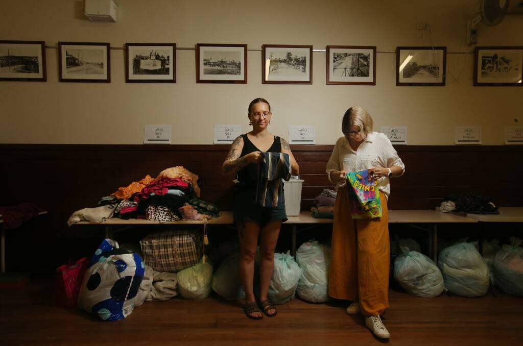Cass Ponchard and Amanda Cochrane sorting through donated items at Abermain Hall. Picture by Simone De Peak 
