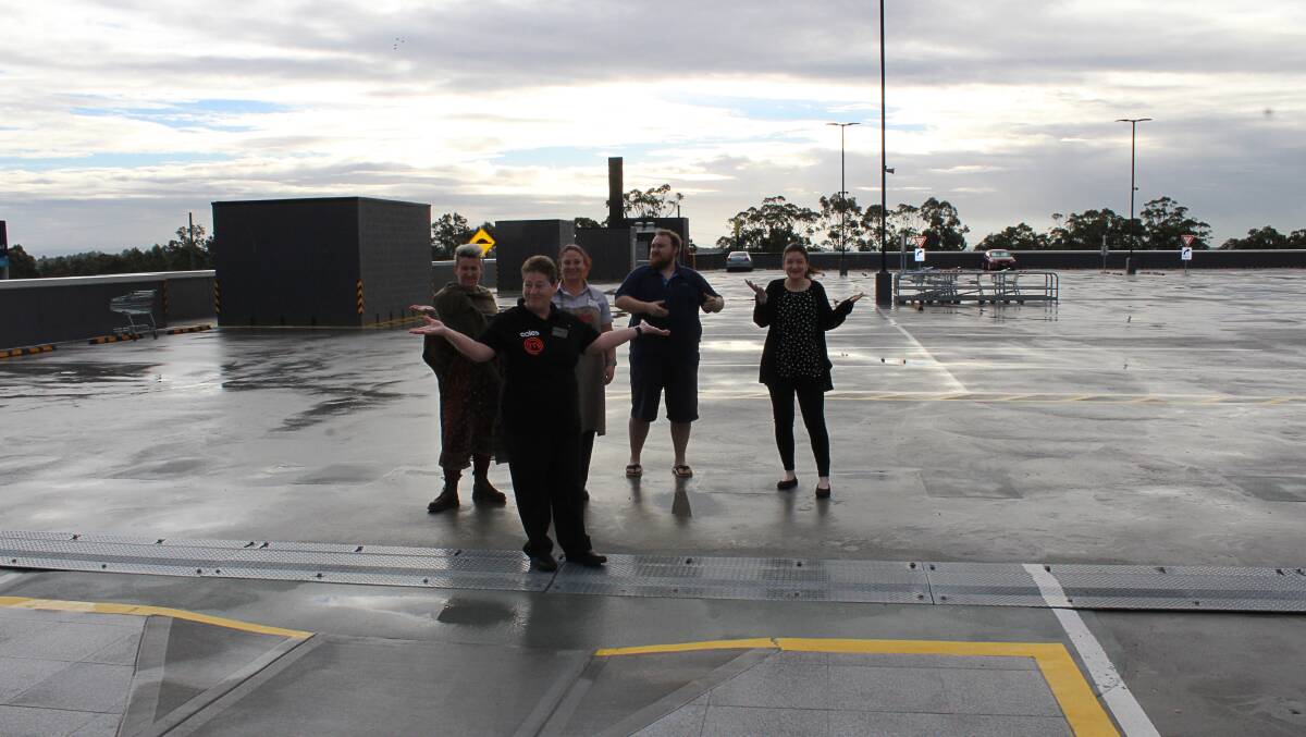 NO PARKING: Stockland employees in an empty Green Hills car park Tuesday morning.