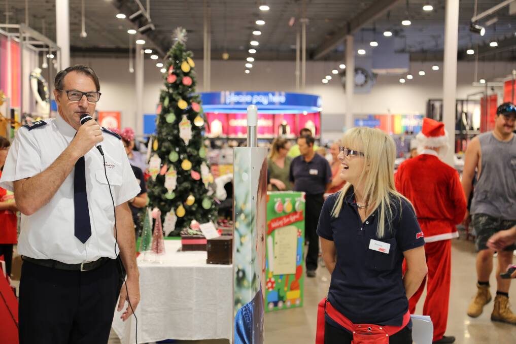 GIVING: Port Stephens Salvation Army Envoy Howard Koutnik with Salamander Bay Kmart store manager Donna Cornnell at the wishing tree appeal launch. 