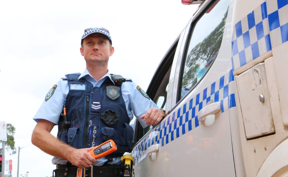 ON THE ROADS: NSW Police Senior Constable Duncan Arnold with a breathalyser. Pictures: Ellie-Marie Watts