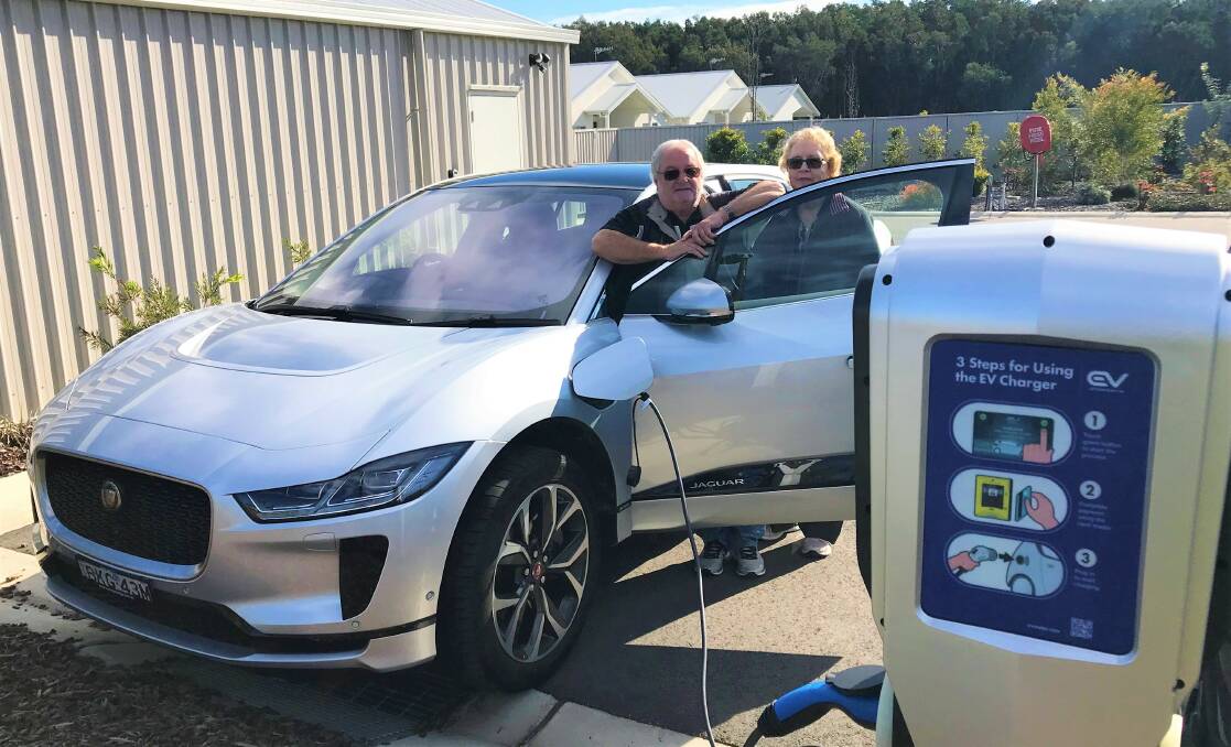 POWER UP: Latitude One residents Brian and Laura George charging their electric vehicle at the Anna Bay over-55s village. The charging station is available to the public. 