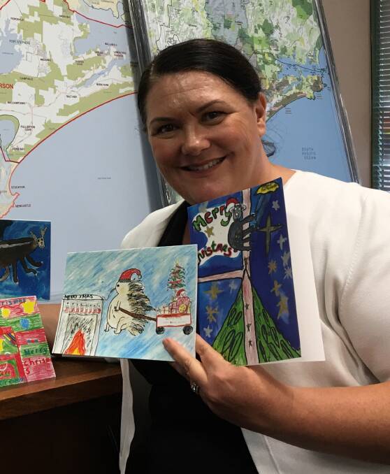 FESTIVE: Paterson MP Meryl Swanson with a selection of Christmas cards. The winning entry is on the far right. Picture: supplied.