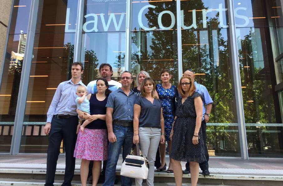 WAGING WAR: Residents of the Williamtown 'red zone' outside the Federal Court of Australia. Gavin and Kim Smith, centre, are the lead applicants in the case against Defence and will allege it failed in its duty of care to residents.